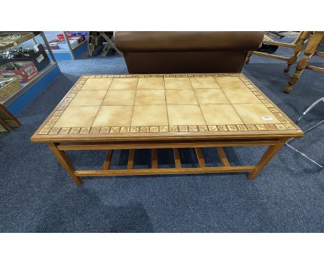 Vintage Ambercraft Tiled Top Coffee Table, cream/beige tiled top on teak base with slatted shelf below.  Measures 40" length 