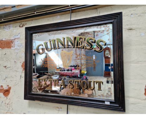 A framed Guiness extra stout advertising mirrorCondition:- General wear through age and use, chip to frame, 3 small damaged a