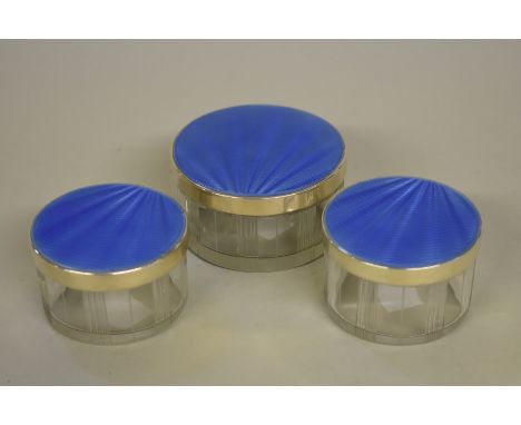 Three silver and enamel lidded dressing jars, byÂ&nbsp;Albert Carter,Â&nbsp;Birmingham 1937. 