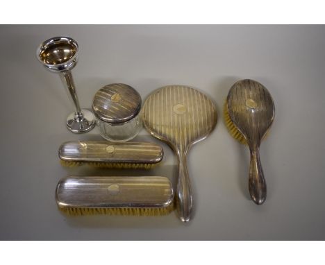 A Continental silver engine turned five piece dressing table set; together with a silver trumpet vase. 