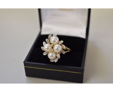 A floral cluster gold ring set four pearl and fourteen diamonds,Â&nbsp;hallmarked 375, 4.9g all in. 