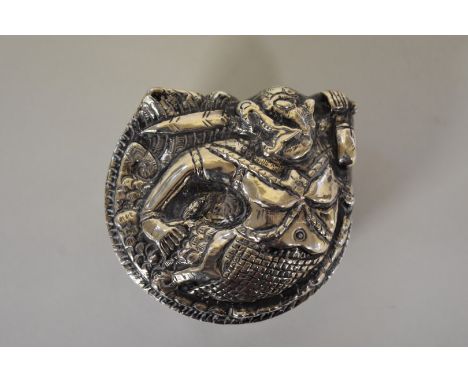 An Indian metal lidded trinket box, decorated mythical warrior, 4cm high. 
