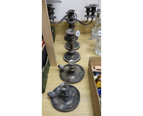 A pair of plated two branch candelabra, a matching candlestick and a pair of chambersticks
