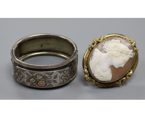 A Victorian carved shell cameo portrait brooch, gilt metal framed and a late Victorian silver bangle (a.f.) (2)