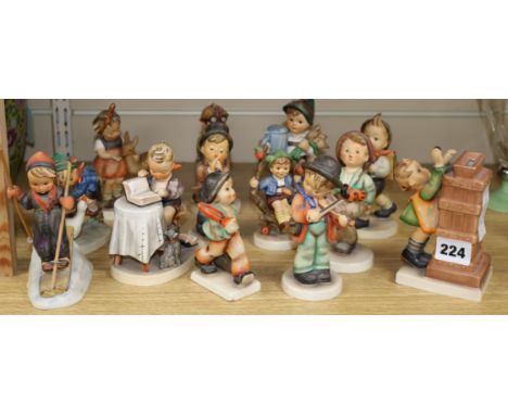 A canteen of thirteen Hummel porcelain figures