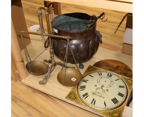 A painted longcase clock dial, an 18th century pot, a set of brass scales and three cooking hangers