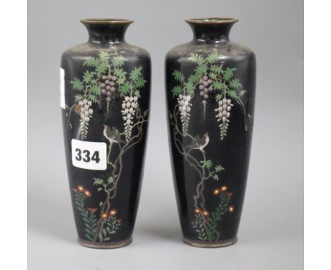 A pair of Japanese cloisonne enamel vases, decorated with flowering prunus, irises and other flowers on a black ground, heigh