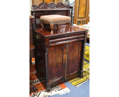 A George IV mahogany chiffonier, with raised panel to the back, open shelf, moulded frieze drawer and two panelled doors flan