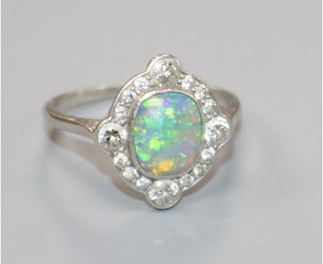 A 1920's white metal, black opal and diamond cluster ring, size P.