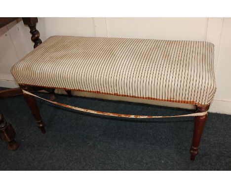 A mahogany rectangular upholstered stool, on baluster turned legs