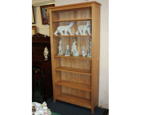 A modern oak bookcase with five adjustable shelves, on bracket feet, purchased from John Lewis, 200cm by 96.5cm