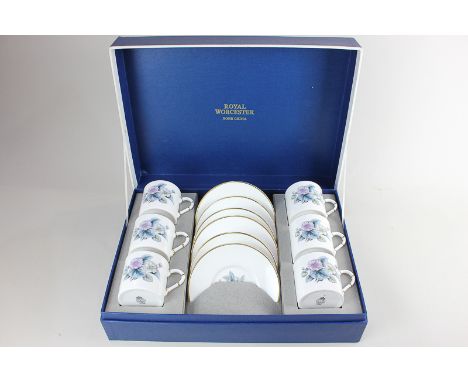 A boxed Royal Worcester porcelain set of six coffee cups and saucers, in the Woodland pattern