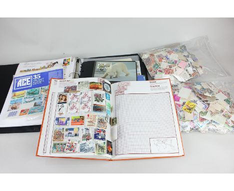 A collection of first day covers, a stamp album and loose stamps, from Great Britain and around the world