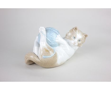 A Nao porcelain model of a kitten playing with a ball of wool, 10cm, sold to support the Cat and Rabbit Rescue