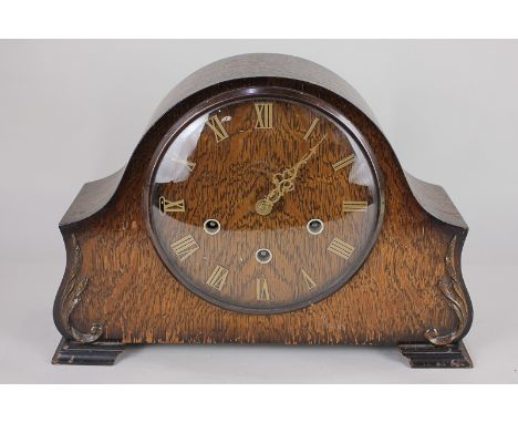 A 20th century Smiths oak cased mantel clock with foliate carved decoration, 23.5cm by 34cm