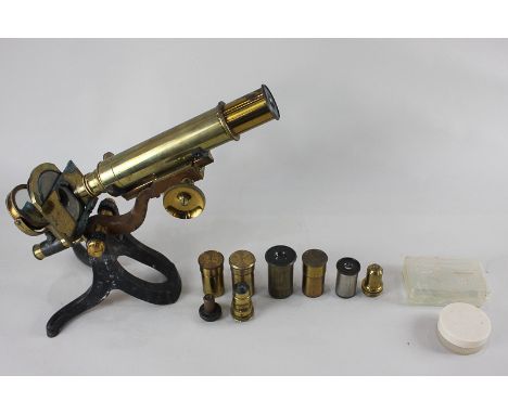 A brass students microscope, the cast iron base marked 3 Fleet Street (?) London, with a collection of different lenses, one 