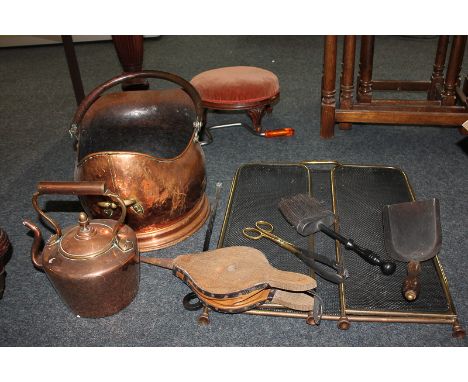 A collection of copper and brass fire tools and accessories, to include coal scuttle, kettle, bellows and a fire guard