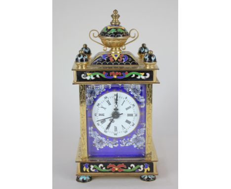 A brass and bevelled glass cased mantel clock, the case with inlaid cloisonne design, the side panels depicting a Japanese sc