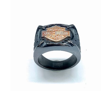 Smooth black band with a copper colored Harley Davidson logo in the front and grey carved scales on either side. Size 12. Con