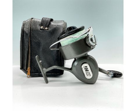 This substantial spinning reel is gunmetal colored with sticker reading, "1938 Hi." This item has its original case which mea