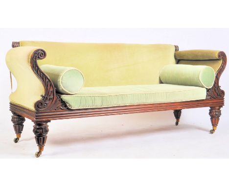 A William IV 19th century mahogany framed three seater settee in green upholstery. The sofa having a straight back over inver