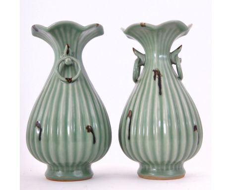 A pair of 17th century Ming Dynasty (1368 to 1644 A.D.) Chinese ceramic Longquan green celadon decorative vases. Each vase ha