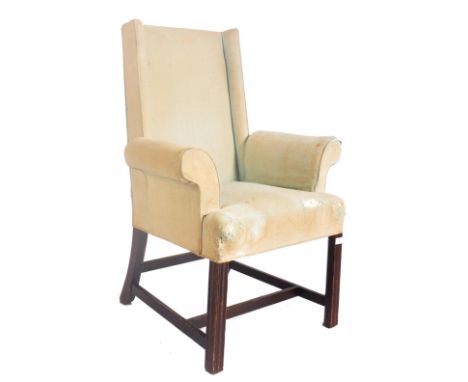 An 18th century mahogany American Federal period manner straight wingback armchair. The elbow chair with a straight wing back