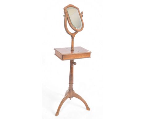 A 19th century Victorian mahogany gentleman's bachelor's shaving stand. The stand comprising of a shield shaped mirror panel 