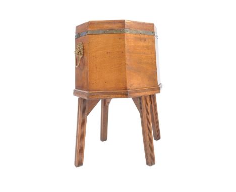 A George III early 19th century mahogany octagonal wine cooler. The wine cooler having an inlaid top with hinged lid and supp