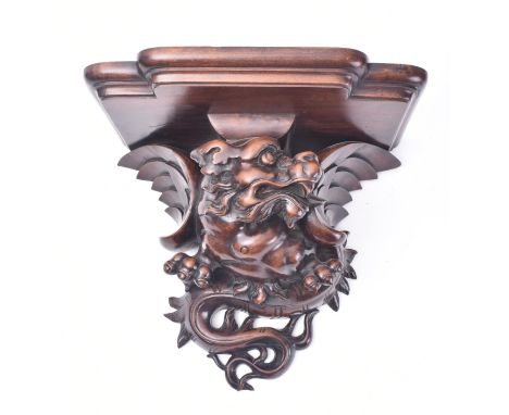 A 19th century French carved walnut in the shape of a dragon wall /&nbsp; clock bracket. The bracket having a breakfront top 