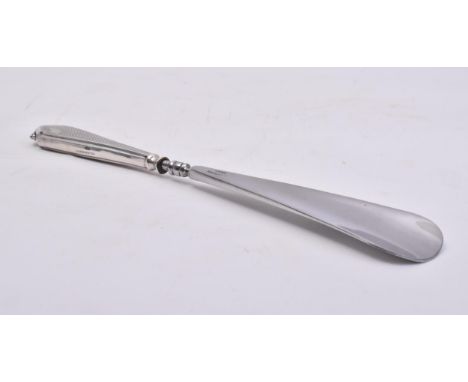 A hallmarked silver handled stainless steel shoe horn. The main body of the shoe horn made from stainless steel with an Art D