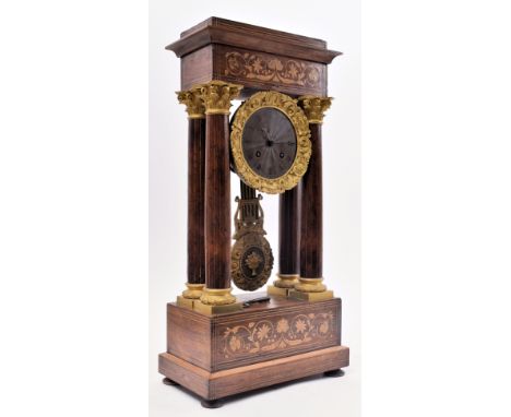 A 19th century continental French rosewood &amp; mahogany marquetry inlaid Portico mantel clock. The clock having a pediment 