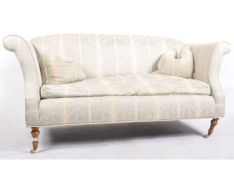 A 20th century upholstered Chesterfield three seater sofa in the manner of Howard &amp; Sons. The sofa having a straight back