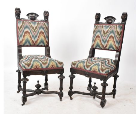 A pair of Victorian 19th century oak Gothic revival Carolean dining chairs. Each chair having a shaped gallery back flanked b