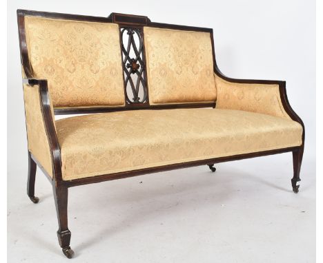 An Edwardian mahogany inlaid two seater sofa settee / salon sofa. The sofa having a twin panel padded backrest with central p