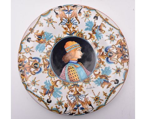 A late 20th century hand painted Italian majolica charger / plate by Luciana Mari. The charger featuring a central portrait o