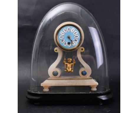 A 19th century Continental French alabaster swinging cherub mantel clock in glass dome. The clock having a round blue enamel 