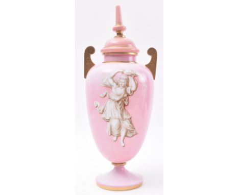 A late 19th Century French opaline pink glass urn. The urn having a finial topped cover with bulbous tapering body below over
