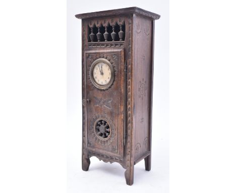 A 19th century French Breton oak mantel clock. The provincial Breton oak case of upright form having spindle gallery over doo