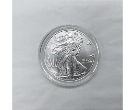 West Point Mint. The obverse side features full length of Liberty in stride. She is shown wrapped in the folds of the flag of