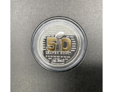 A collectible National Football League coin celebrating Super Bowl 50; Carolina Panthers verses the Denver Broncos. Fine silv