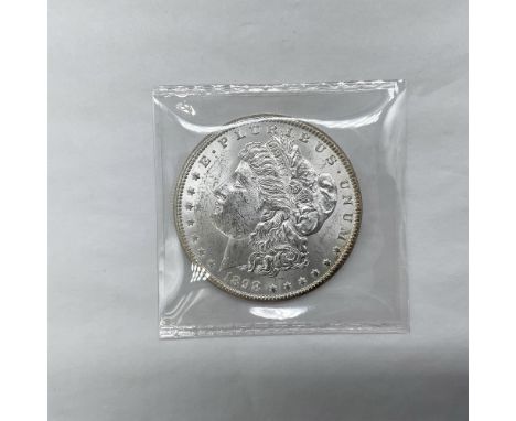 Struck at the now defunct New Orleans Mint. The obverse side features Liberty in profile. She is shown in cap, flora, and cro