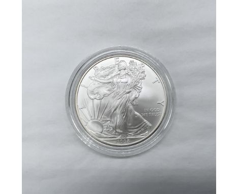 West Point Mint. The obverse side features full length of Liberty in stride. She is shown wrapped in the folds of the flag of