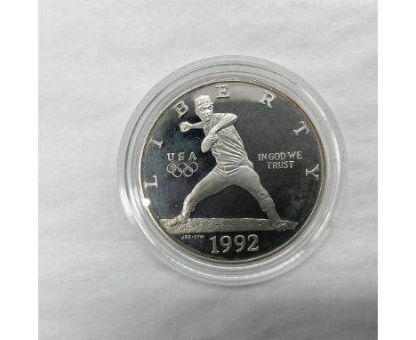 San Francisco Mint. The obverse side depicts a baseball pitcher in motion. The reverse side features the American flag coat o