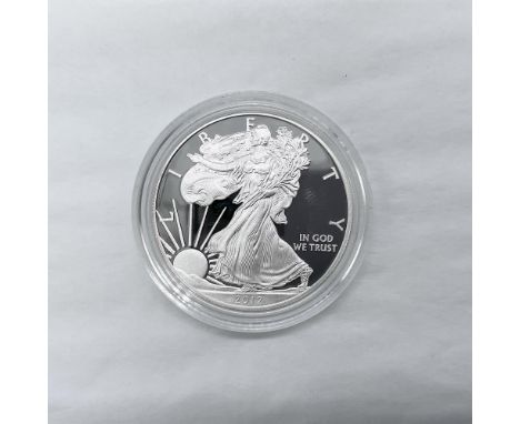 West Point Mint. The obverse side features full length of Liberty in stride. She is shown wrapped in the folds of the flag of