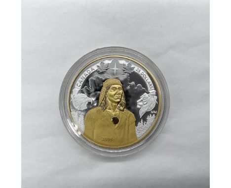 A Canadian $25 fine silver coin with gold plating. The obverse side depicts Queen Elizabeth II facing right, as at the age of