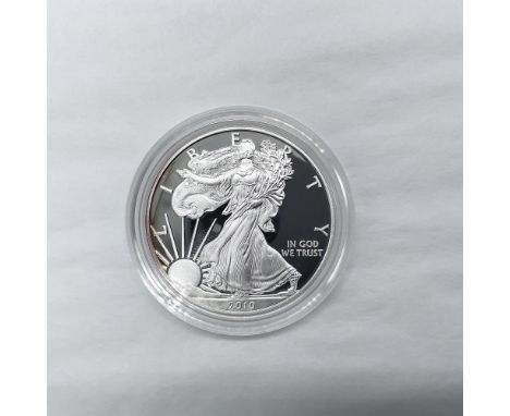 West Point Mint. The obverse side features full length of Liberty in stride. She is shown wrapped in the folds of the flag of