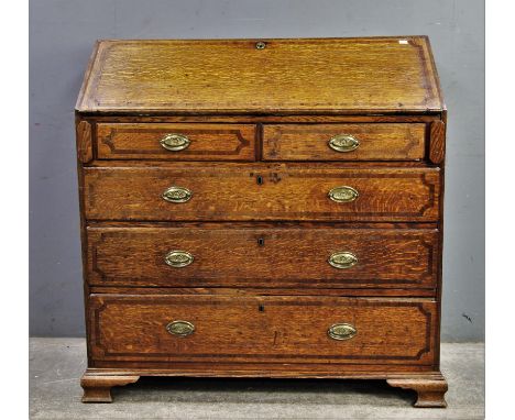19th Century oak fall front bureau with mahogany inlay, fall opening to reveal door flanked by four small drawers to each sid