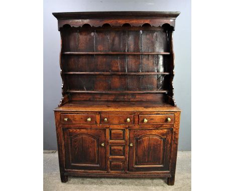 A mid 19th Century oak Dresser, plate rack with cornice over three shelves above base of three short drawers over central pan