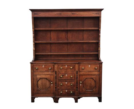 Oak dresser, 19th Century, the upper tier with three shelves, the base with four central  frieze drawers, flanked by frieze d